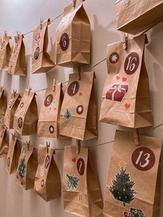 brown paper bags hanging on a wall decorated with numbers and christmas tree decorations for the holiday season