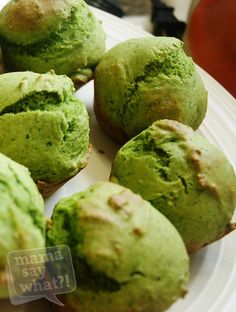 some green muffins are on a white plate