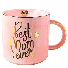 a pink and gold coffee mug with the words best mom ever written in gold on it