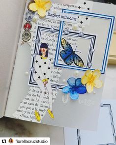 an open book with flowers and butterflies on it