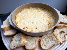 a white plate topped with bread slices and a casserole dish filled with cheese