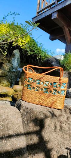 an orange basket sitting on top of some rocks