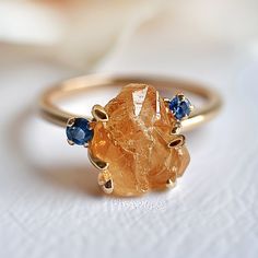 *Gem: Citrine, sapphires (can be customized with other stones as well) *Send us a message to select your favorite citrine gemstones💛🧡 All 12 months birthstones are available for accent stones. Pick any in your choice:) *Metal Solid Silver/14k Gold: These are the metals for durable 24/7 every day wear.  *Our raw stones are hand selected, and set on a beautiful shank for a one-of-a-kind work of art. Every art piece is handmade and varies slightly, just made for the same unique you! *Please note Citrine Engagement Ring, Citrine Ring Engagement, Birthstones By Month, Raw Citrine, Multiple Rings, Raw Stone Ring, Studded Necklace, Jewelry Picture, Citrine Ring