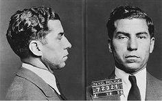 two men in suits and ties looking at each other with mugs on their faces