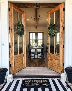 an open door leading to a dining room with chairs and table in it on a black and white striped rug