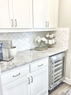 a kitchen with white cabinets and marble counter tops is featured in the magazine butter'n pantry