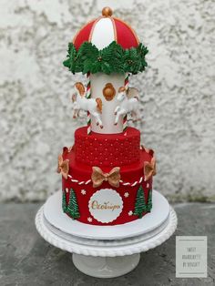 a three tiered cake decorated with christmas decorations