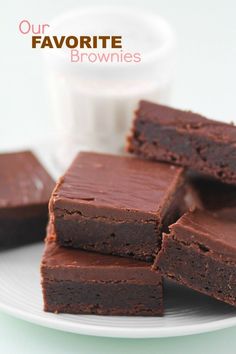 chocolate brownies on a plate with a glass of milk