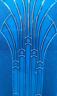 an art deco glass window with blue and white designs