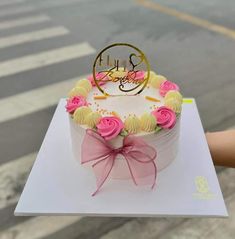 a birthday cake with pink and yellow frosting