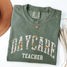 Introducing the Comfort Colors Daycare Teacher Shirt, a perfect blend of style and comfort for the dedicated educators in your life. This cute "Infant Squad" shirt makes an ideal Back To School gift, celebrating the teamwork and passion of daycare teachers everywhere🤍 ♥ DESCRIPTION: This is a Comfort Colors Unisex t-shirt that is 100% ring-spun cotton, soft-washed, garment-dyed fabric brings extra coziness to your wardrobe while the relaxed fit makes it an excellent daily choice. The double-nee Cheap Name Print T-shirt For Daycare, Daycare Teacher Gifts, Daycare Teacher, Squad Shirt, Teacher Outfits, School Gift, Gift Cute, Back To School Gifts, School Shirts