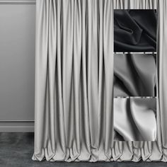 an open curtain with black and white draperies hanging on the wall next to it