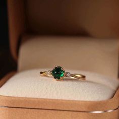 Handmade delicate minimalist emerald gold ring, beautiful 5mm round green emerald gemstone, with 2 cz diamond side stones, gold lace tapered open band. Stunning emerald looks timeless and elegant, luxurious vintage accent. Handcrafted dainty piece, super exquisite, perfect gift idea for your loved one and yourself! 💎 Features: ♥ Material: Finest gold plated brass ♥ Main stone: Emerald green zircon ♥ Side Stone: Cz diamond ♥ Open adjustable band, fits US size 4-10 💎 Details: ♥ Approximate Measurements: - Main stone diameter: 5mm - Band width: 1.8mm ♥ Lightweight, easy to wear ♥ Nickel/Lead Free, Hypoallergenic, good for sensitive skins 🎁 Packing & Shipping: ♥ All our jewelry will be shipped with beautiful gift wrap packaging ♥ Handwrite gift notes/cards available upon request ♥ SAME DAY& Emerald Gold Ring, Emerald Ring Vintage, Lace Ring, Packaging Gift, Emerald Engagement, Wedding Rings Vintage, Gold Lace, Emerald Stone, Emerald Engagement Ring