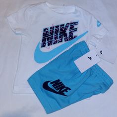 New Never Worn With Tags. Nike Set Includes A White Short Sleeve Cotton Blend Tee With Blue And Black Trim And "Nike" Inscription And Classic Check Logo On Front And Left Sleeve. Bottoms Are Blue Cotton Blend Design With Blavk And White Trim And Elastic Waistline And Nike Check Logo And Inscription On Left Leg. Set Fits 2 Toddler Boys. Any Questions, Please Contact Me. Thanks! Nike White Summer Sets, White Nike Summer Sets, Nike Blue Cotton Sets, Nike White Short Sleeve Sets, Nike White Sets For Spring, Nike Check Logo, Check Logo, Nike Set, Boy Fits