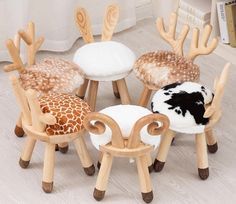 four wooden stools with different designs on them