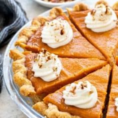 several slices of pumpkin pie with whipped cream on top