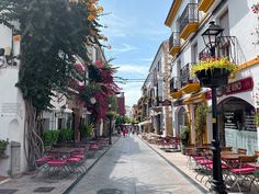 an empty street lined with tables and chairs