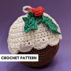 a crochet pattern for a cupcake with holly leaves on top, sitting on a purple surface