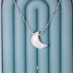 Experience the enchanting beauty of our crescent moon pendant necklace, adorned with a shimmering blue flash moonstone. Made with solid 925 sterling silver and platinum plating, this pendant is not only elegant but also built to last. Elevate your everyday jewelry collection or surprise your loved ones with this exquisite piece. Pendant dimensions: 0.68 x 0.48 inNecklace length: 17.5 in with the adjustable ballMaterials: moonstone, 925 sterling silver Jewelry Care: See more information about how White Sterling Silver Necklace With Moon Charm, White Moon Charm Necklace, White Half Moon Necklace With Moon Charm, Silver Half Moon Moonstone Jewelry, Silver Crescent Moonstone Necklace, White Half Moon Celestial Jewelry, Elegant Crescent Moonstone Necklace, Minimalist White Crescent Necklace, Moonstone Half Moon Necklace With Moon Charm