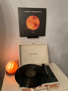 a record player sitting on top of a white table