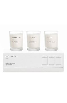 three candles sitting on top of a white box