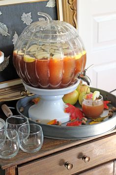 an apple cider on a tray with wine glasses