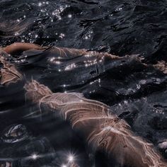 a woman floating in the water with her back turned