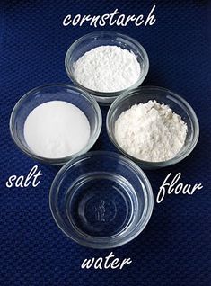 three bowls with flour and salt in them on a blue tablecloth next to each other