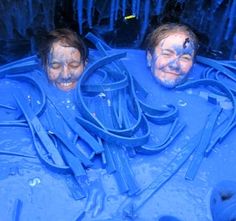 two people covered in blue paint are smiling