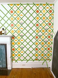 a living room with a fireplace and wallpaper on the walls that has circles painted on it