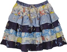 A cute floral cotton short skirt with six ruffled layers in summer shades of blue color in prints.  This bouncy bohemian short skirt is an ideal outfit choice for hot summer weather. #tlb #TieredSkirt #vacationclothing #beachwrap #Floral #Printed #bohemianfashion #ColorfulShortSkirt #BeachSkirt #RuffledSkirt Tiered Floral Print Beach Skirt, Tiered Summer Skirt For The Beach, Multicolor Tiered Skirt With Floral Print, Blue Tiered Mini Skirt For Vacation, Casual Tiered Mini Skirt For Beach, Casual Tiered Mini Skirt For The Beach, Blue Ruffled Mini Skirt For Beach, Bohemian Cotton Ruffle Mini Skirt, Cotton Tiered Skirt For Vacation