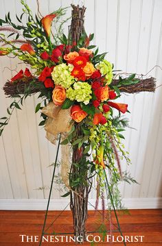 a cross made out of branches and flowers