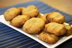 a white plate topped with cookies on top of a blue and white striped table cloth