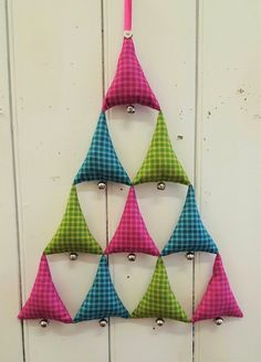 a christmas tree made out of fabric hanging on a wall