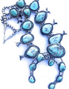 Pre-owned BRAND : NizhoniTradersLLC TYPE : Necklace MAIN STONE CREATION : Natural SIGNED : Yes COLOR : Blue STYLE : Beaded MAIN STONE COLOR : Turquoise METAL : Sterling Silver SECONDARY STONE : Turquoise ETHNIC ORIGIN : Navajo MAIN STONE : Turquoise VINTAGE : Yes A true collectors piece! Amazing Vintage Navajo Kingman Turquoise and Sterling Silver Navajo Pearl Jumbo Squash Blossom Necklace. Beautiful stones in this necklace! Necklace measures 30 inches long. Naja pendant is an additional 4 inche Naja Pendant, Beautiful Stones, Squash Blossom Necklace, Navajo Turquoise, Squash Blossom, Blowout Sale, Color Turquoise, Vintage Navajo, Kingman Turquoise