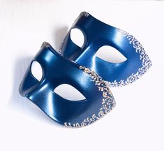 Elevate your masquerade look with this sophisticated men's mask, available in black or blue. Choose from elegant gold, shimmering silver, or mysterious black onyx filigree detailing to complete your style. Perfect for masquerade balls, formal events, or themed parties, this mask is designed to provide a refined, masculine touch to any outfit. Age Group/Gender - Adult/Mens Size/Type - One size fits all adults Mask Color - Navy Blue / Black Filigree Color - Gold / Silver Mask Material - Plastic Ac Blue Masquerade Mask, Mardi Gras Kid, Kids Party Packs, Mens Masquerade Mask, Silver Mask, Female Mask, Blue Mask, Masquerade Mask, Masquerade Ball