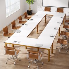 an empty conference table with chairs around it