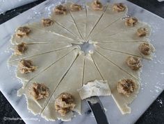 a white marble board topped with food and a knife