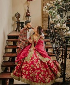 a bride and groom are sitting on the stairs