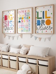 three framed pictures hang on the wall above a bench with storage bins underneath them