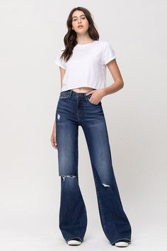 Elevate your denim game with these Flying Monkey High Rise Distressed Wide Leg Jeans. These jeans boast a high-rise waist for a flattering silhouette, while the wide leg design adds a touch of retro elegance. The distressed detailing infuses an edgy element, making these jeans a versatile choice to effortlessly combine modern trends with a hint of vintage-inspired style.F. Rise: 10"Inseam: 34'' Leg Opening: 22''Model is 5' 8'' Wearing size26Fabric Contents: 93% Cotton, 5% Polyester, 2% Spandex, Distressed Wide Leg Jeans, Half Sleeve Blouse, Vintage Flare, Flying Monkey Jeans, Flying Monkey, Judy Blue Jeans, Modern Trend, Chic Accessories, Women Clothing Boutique