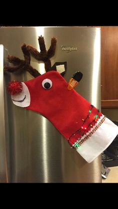 a reindeer head hanging on the side of a refrigerator