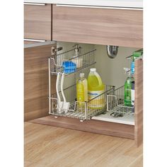 an open dishwasher drawer with cleaning products in the bottom shelf and under it