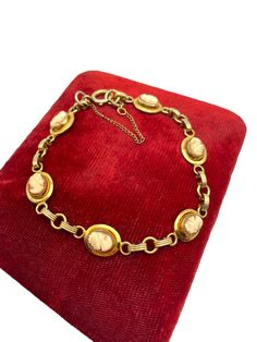 Adorable 12K Gold Filled Cameo Bracelet - GF Links Bracelet with Oval Resin Cameo - Vintage Mid Century Jewelry 1950s MCM Description: Beautiful gold filled bracelet that is circa mid-century.  This bracelet is 12K gold-filled and has 6 oval cameos alternating with gold filled links.  The women in the cameos alternate with left and right facing.  The locket also has a safety chain attached to provide some additional security on the lovely piece to keep it from getting lost. The spring ring on the safety chain is marked ATLAS for the Atlas Mfg. Co. that operated in New York, New York circa 1950. Size: The bracelet is 8'' long Weight: 9.1 grams Condition: In nice vintage condition with wear commensurate with vintage age (circa 1950s/mid-century).  Some light wear to the piece.  See photos fo Links Bracelet, Cameo Bracelet, Font Face, Mid Century Jewelry, Safety Chain, Cute Bracelets, Chain Link Bracelet, Spring Rings, Link Bracelets