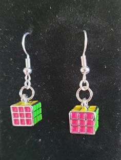 a pair of earrings that have been made out of rubikt cubes on them