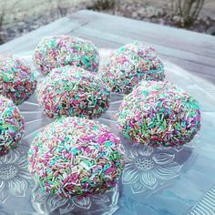 sprinkle covered donuts on a clear plate