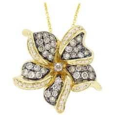 This beautiful flower shaped pendant designed by Le Vian features approximately 1.50CTW of diamonds. Designer: Le Vian Gemstone: Diamond Diamond Carat Weight: Approximately 1.50CTW Diamond Cut: 70 Round Brilliant Color: 39 Chocolate Color, 31 Average G-J Clarity: Average SI-I Metal: 14K Yellow Gold Marked/Tested: Stamped "LEVIAN” and "14KT” Weight: 5.1 Grams Chain Length: 18” Long Pendant Length: Approximately 1" Flower Diamond Necklace, Levian Chocolate Diamonds, Diamond Flower Pendant, Contemporary Necklace, Chocolate Diamonds, Le Vian, Gold Diamond Necklace, Chocolate Color, Flower Pendant Necklace