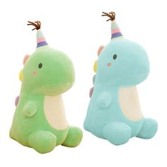 two stuffed animals sitting next to each other on a white background, one is green and the other is blue