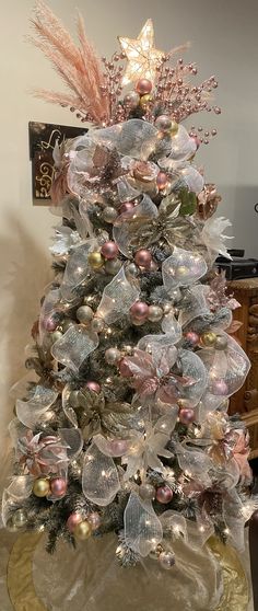 a decorated christmas tree sitting on top of a table