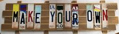 a wooden sign that says make your own with different colors and letters on the front